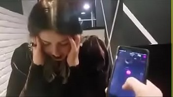 cute girl with remote vibrator in public